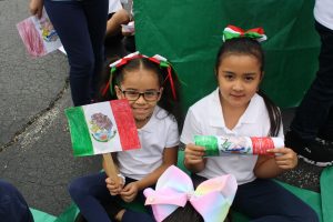 girls sitting with flags