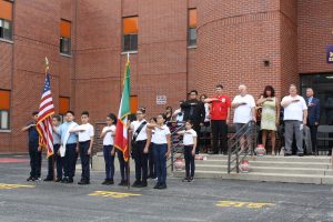 students saluting flag