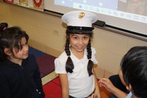 girl wearing Marine Corps hat